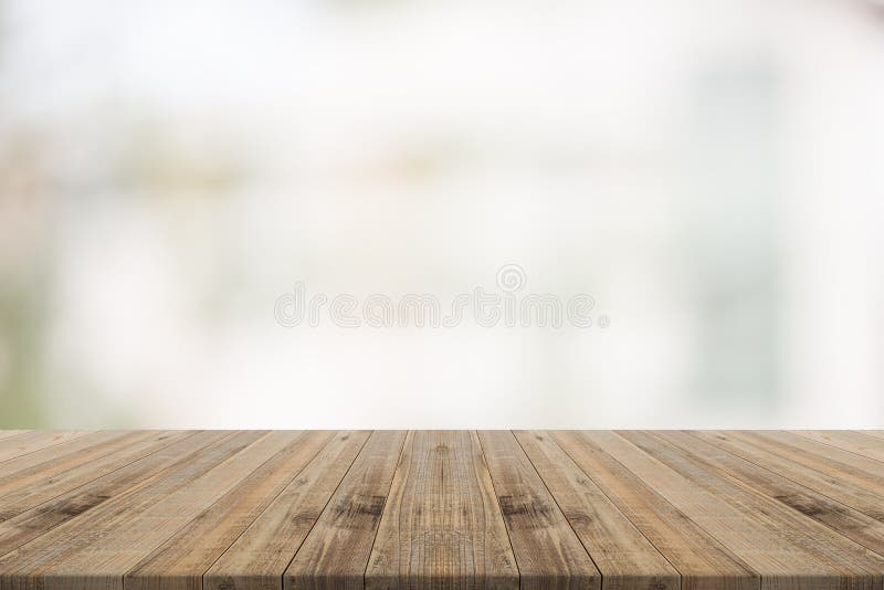 Wood table top on white blurred background from building