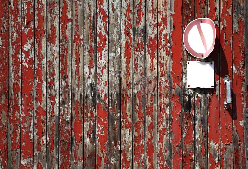 Red and grey wood texture with weathered planks, rough background with free copy space and blank signs on a post. Red and grey wood texture with weathered planks, rough background with free copy space and blank signs on a post