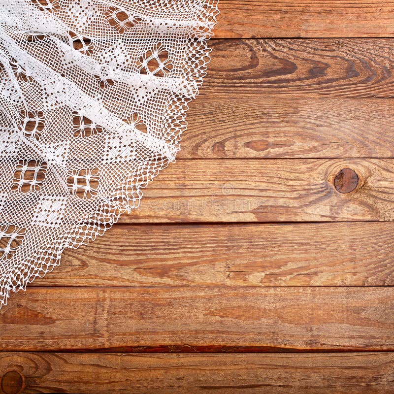 Wood texture, wooden table with white lace tablecloth top view.