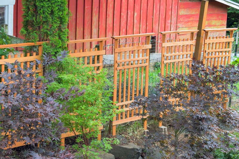 Wood Trellis Covering Red Barn Fencing