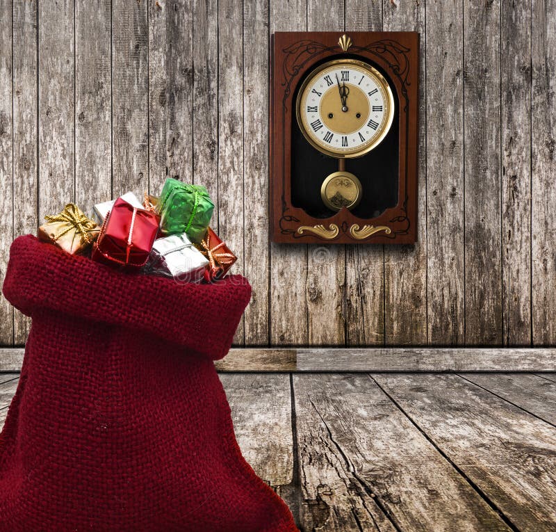 wood wall with a clock showing the time is five minutes to twelve