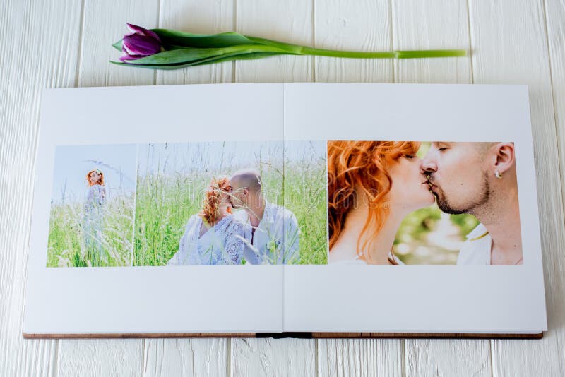 Wood wedding photo book. Happy young couple in love. Bride and groom walking of wedding day.