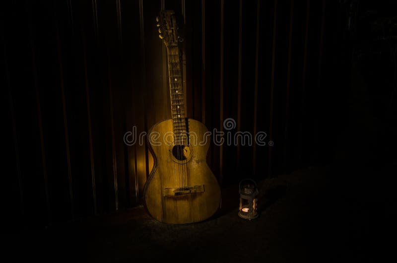 An Wooden Acoustic Guitar is Against a Grunge Textured Wall. the Room ...