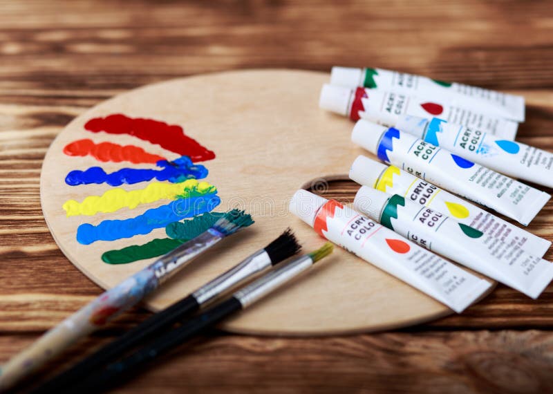 Wooden Art Palette with Tubes of Oil Paints and a Brush. Art and