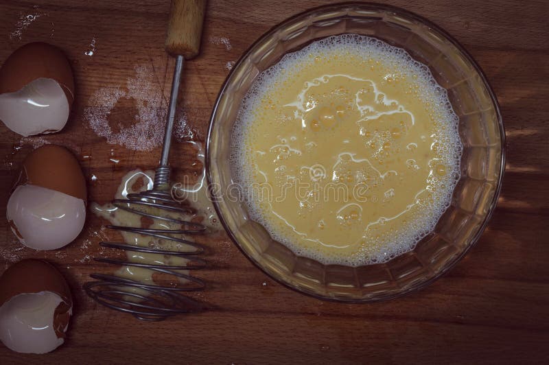 Eggshell, Whisk, Deep Glass Bowl, in a Bowl a Mixture of Eggs and Milk