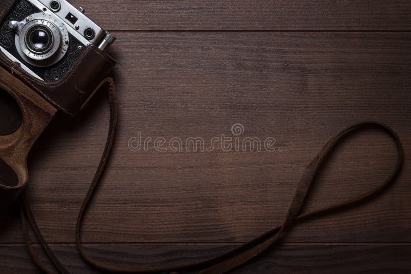 Wooden background with retro still camera