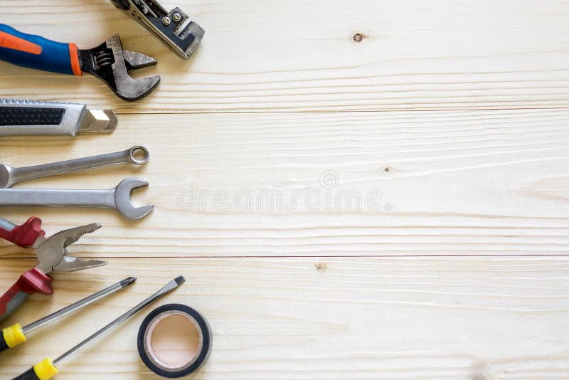 Wooden background with a tools. Banner for a hardware store and a building company. Screwdrivers, pliers, electrical tape.