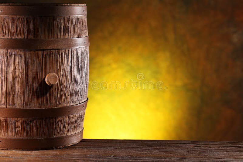 Wooden barrel on a dark yellow background. Wooden barrel on a dark yellow background.