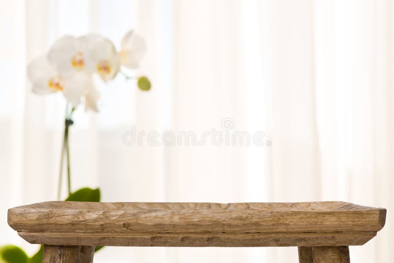 Wooden bathroom table on abstract blurred background with orchid flower royalty free stock photography