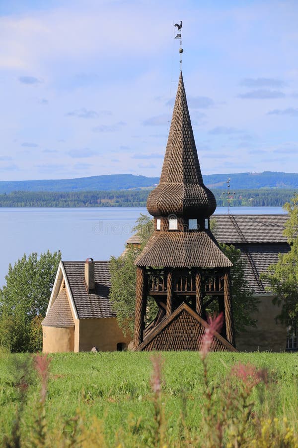Wooden bell cage in Sweden, built in 1752, with Hackas church and lake Storsjon in background