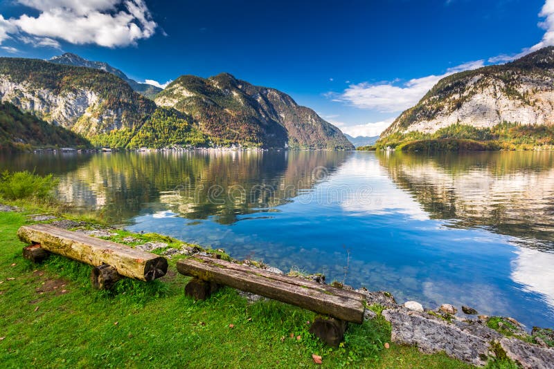 Wooden bench at mountain lake in the Alps