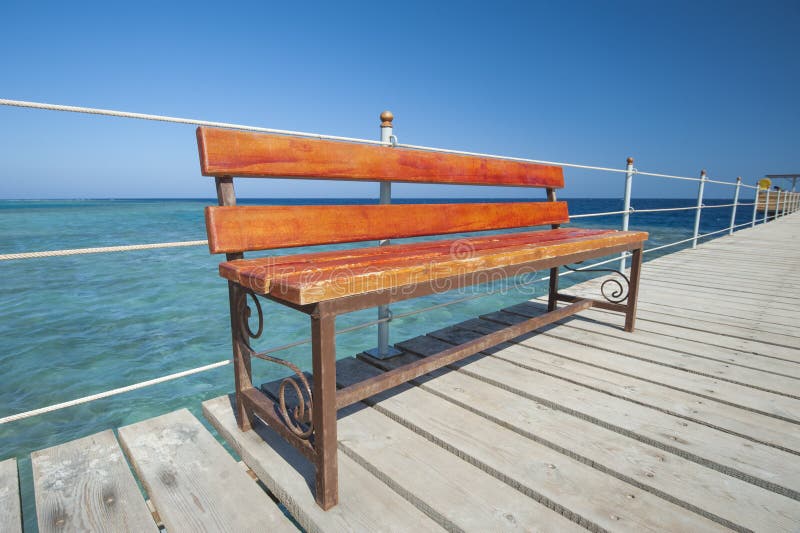 Wooden bench on tropical jetty