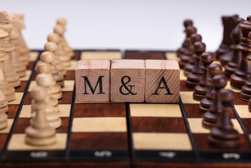 Wooden Blocks With Mergers And Acquisitions Text On Chess Board stock photos Wooden Blocks With Mergers And Acquisitions Text On Chess Board stock photos