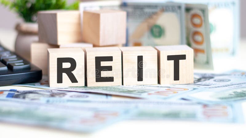 Wooden blocks with text reit and banknotes on table, concept royalty free stock photos