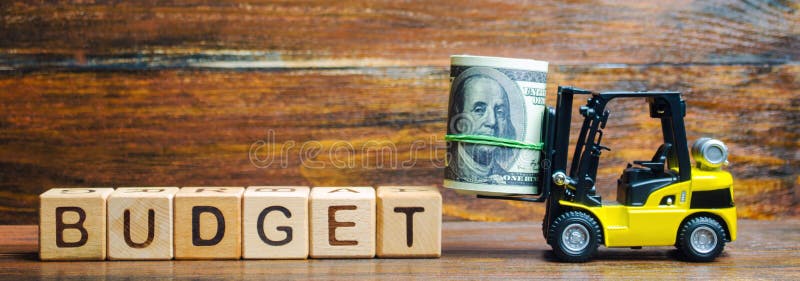 Wooden blocks with the word Budget, money and a forklift. Business and finance concept. Profit and income in the company.