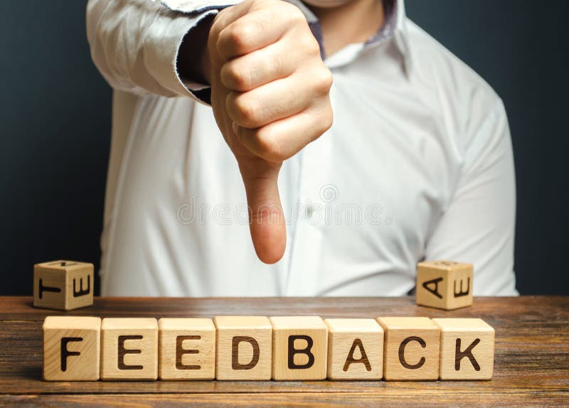 Wooden blocks with the word Feedback and finger down. The concept of the bad rating of hotels and restaurants. The evaluation of stock photo Wooden blocks with the word Feedback and finger down. The concept of the bad rating of hotels and restaurants. The evaluation of stock photo