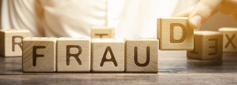 Wooden blocks with the word Fraud and man. Cheating white-collar . The crime. Theft of another`s property. Anti-corruption in the royalty free stock photography Wooden blocks with the word Fraud and man. Cheating white-collar . The crime. Theft of another`s property. Anti-corruption in the royalty free stock photography