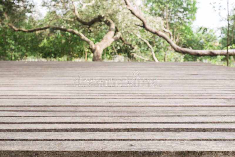 Wooden board empty table in front of blurred background. Perspective grey wood over blur trees in forest - can be used for. Display or montage your products stock image Wooden board empty table in front of blurred background. Perspective grey wood over blur trees in forest - can be used for. Display or montage your products stock image