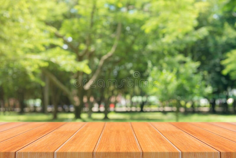Wooden board empty table in front of blurred background. Perspective brown wood table over blur trees in forest background. royalty free stock photography Wooden board empty table in front of blurred background. Perspective brown wood table over blur trees in forest background. royalty free stock photography