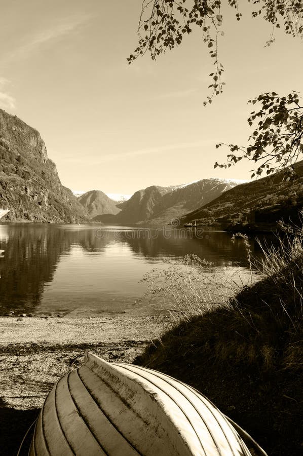 Wooden Boat at Mountains Lake - Sepia Landscape