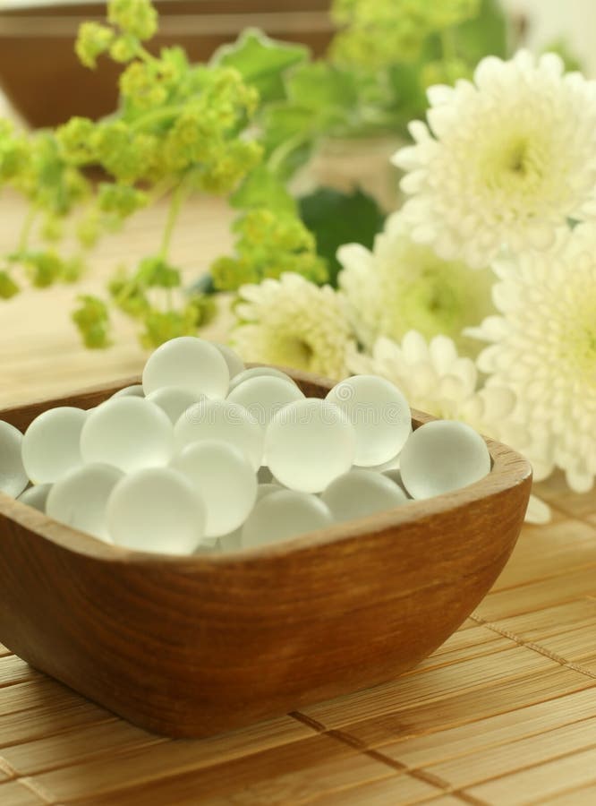 Wooden bowl of decorative balls and flowers