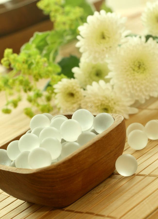 Wooden bowl of decorative balls and flowers