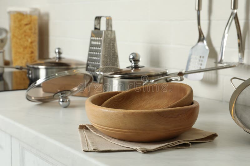Wooden Bowls and Different Cooking Utensils on Kitchen Counter Stock