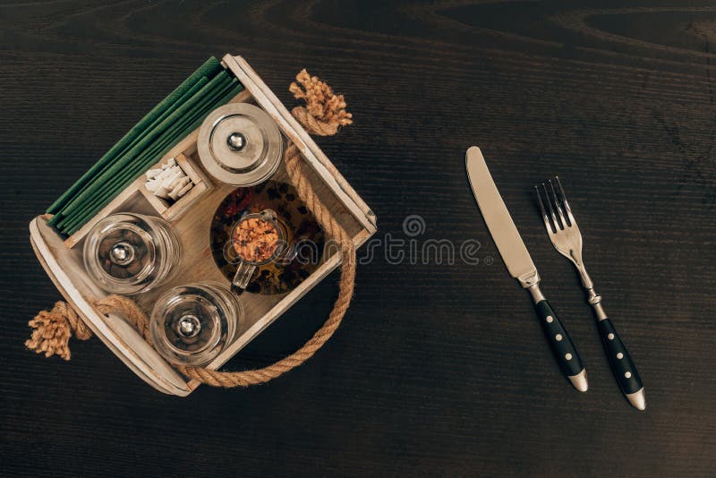 Wooden Box with Olive Oil and Pepper Grinder on Wooden Table Stock