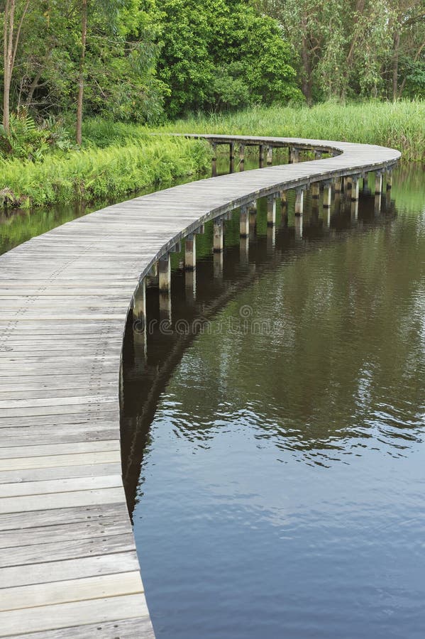 Makeshift wooden bridge over water Stock Photo - Alamy