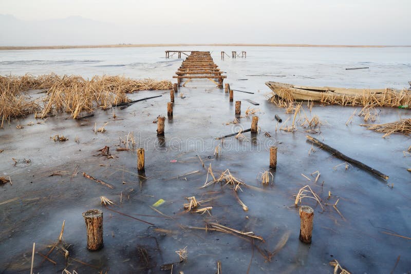 Wooden bridge in frozen lake