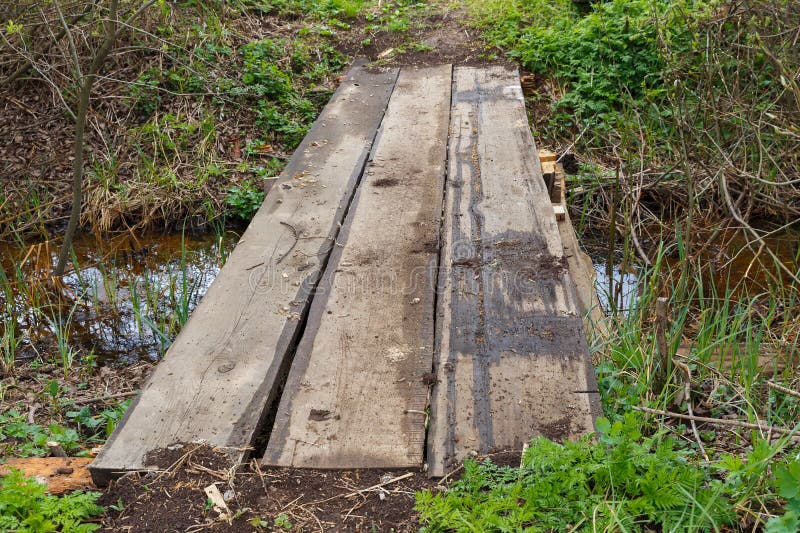 Wooden bridge over a stream in the forest royalty free stock images