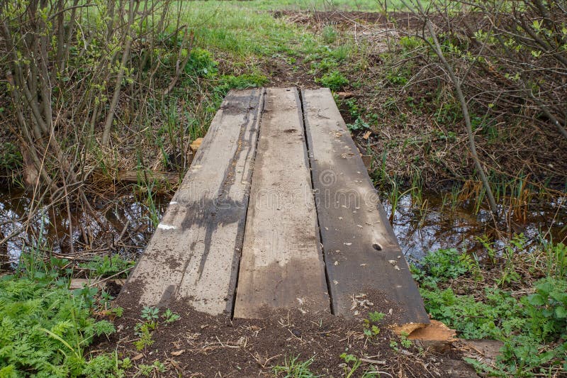 Wooden bridge over a stream in the park. stock images