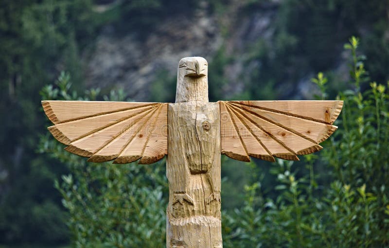 Wooden carved eagle on top of totem pole