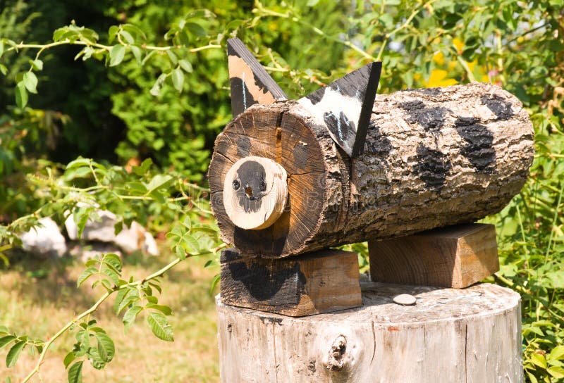 Wooden cat in a landscape design