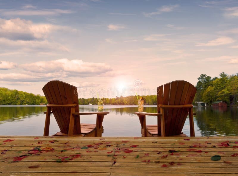Wooden chairs on a lake deck
