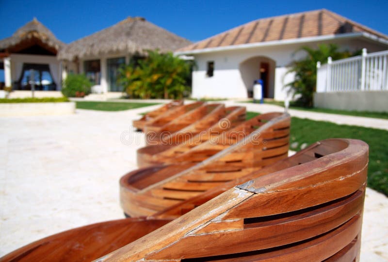 Wooden chairs near swimming pool