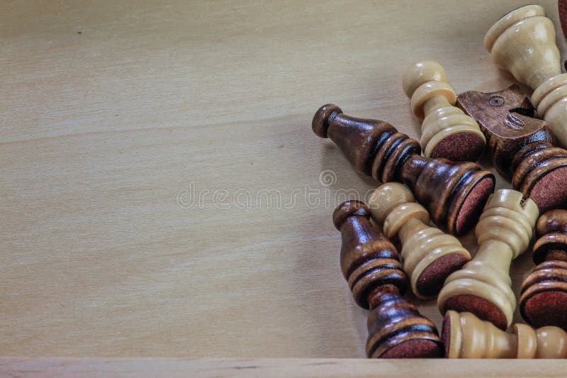 Wooden chess pieces wooden background.