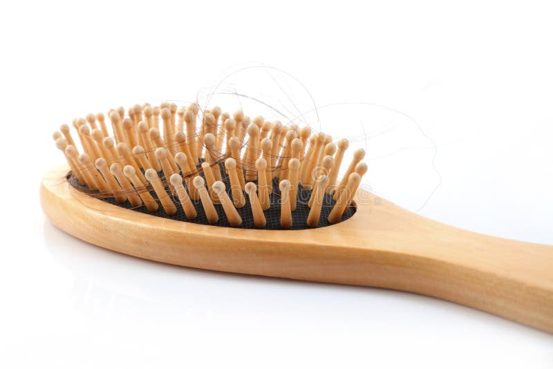 Wooden comb brush with lost hair stock photo Wooden comb brush with lost hair stock photo