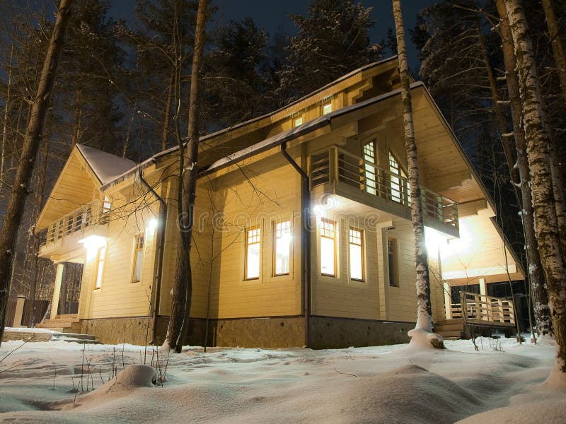 Wooden country house in the forest at night