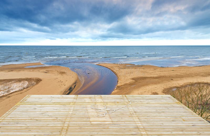 Wooden deck floor over sand beach of the Baltic Sea, Latvia