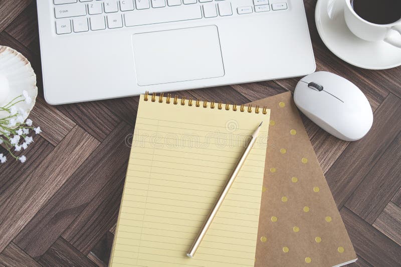 Wooden desk table with laptop computer, coffee cup and mouse. Floor plan. stock images