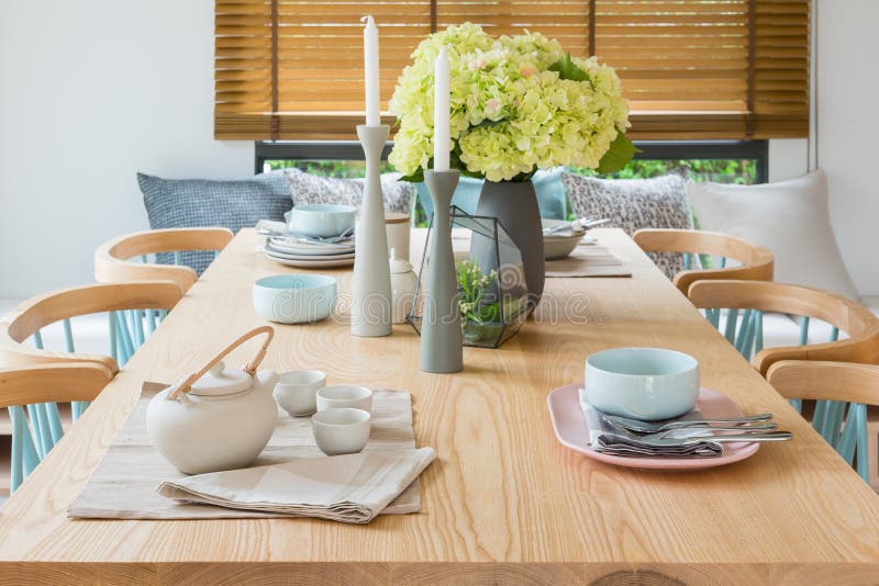 Wooden Dining Table in Modern Dining Room with Table Set and Vase of