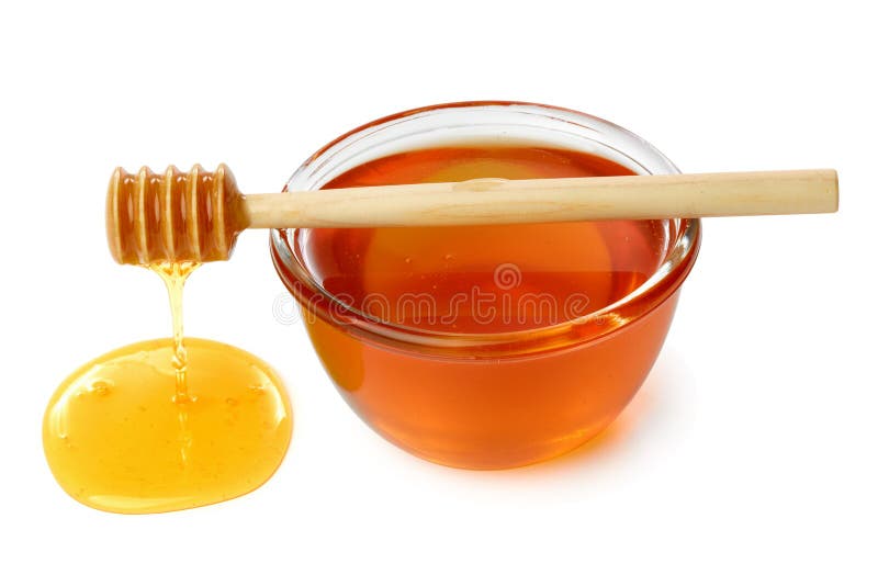 Wooden dipper with bowl of honey.