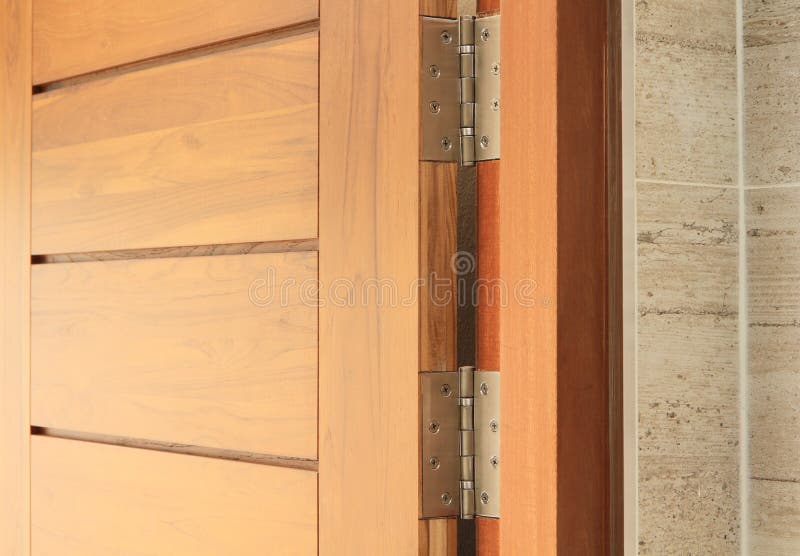 Wooden door with hinge built on tiled wall