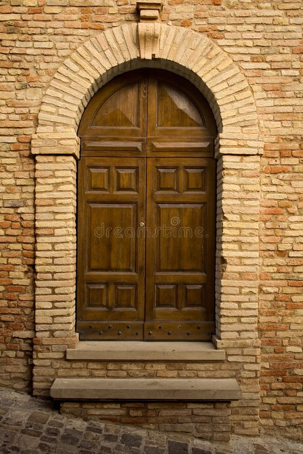 Wooden door in stone archway stock photo