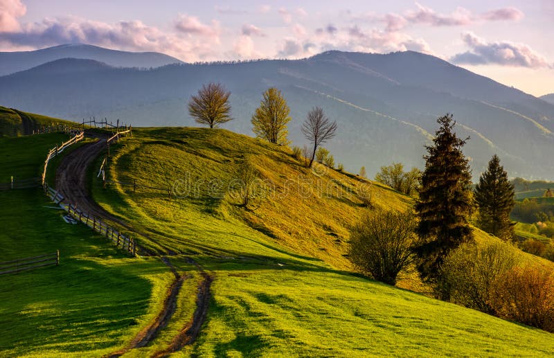 Wooden fence along the path in mountains