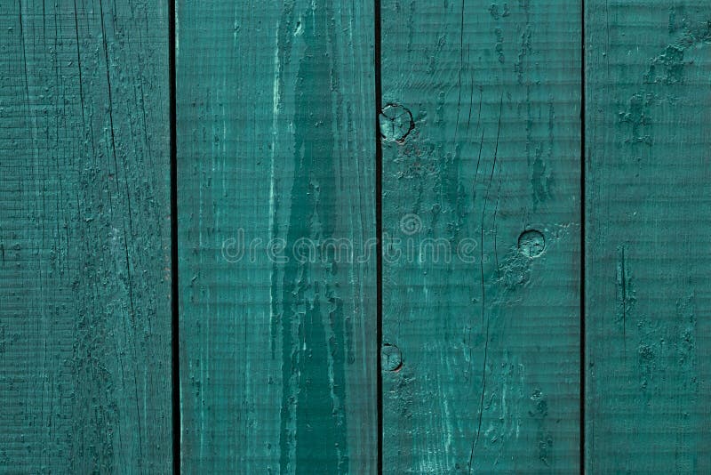 Wooden fence cracked paint. Rough wooden boards painted green. Wood texture background, oak wood wall fence. Green wooden fence