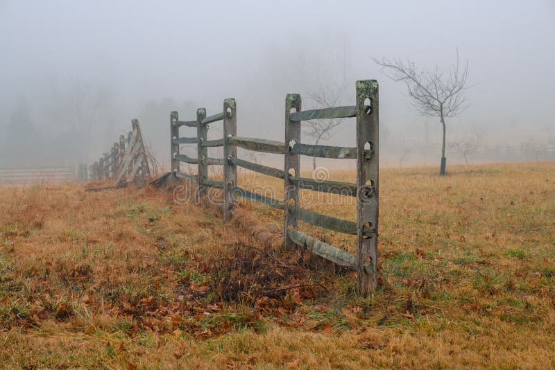 A wooden fence on a foggy winter morning on the Gettysburg National Military Park in Gettysburg, PA, USA stock photo