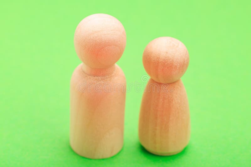 Wooden figures on green background: minimalist design with natural texture royalty free stock image