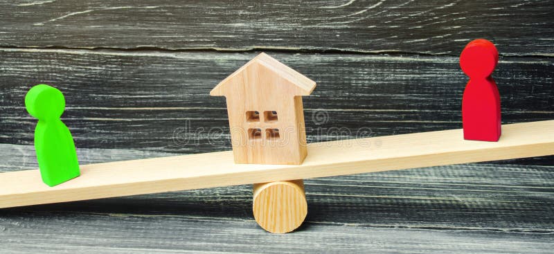 Wooden figures on the scales. clarification of ownership of the royalty free stock photos Wooden figures on the scales. clarification of ownership of the royalty free stock photos